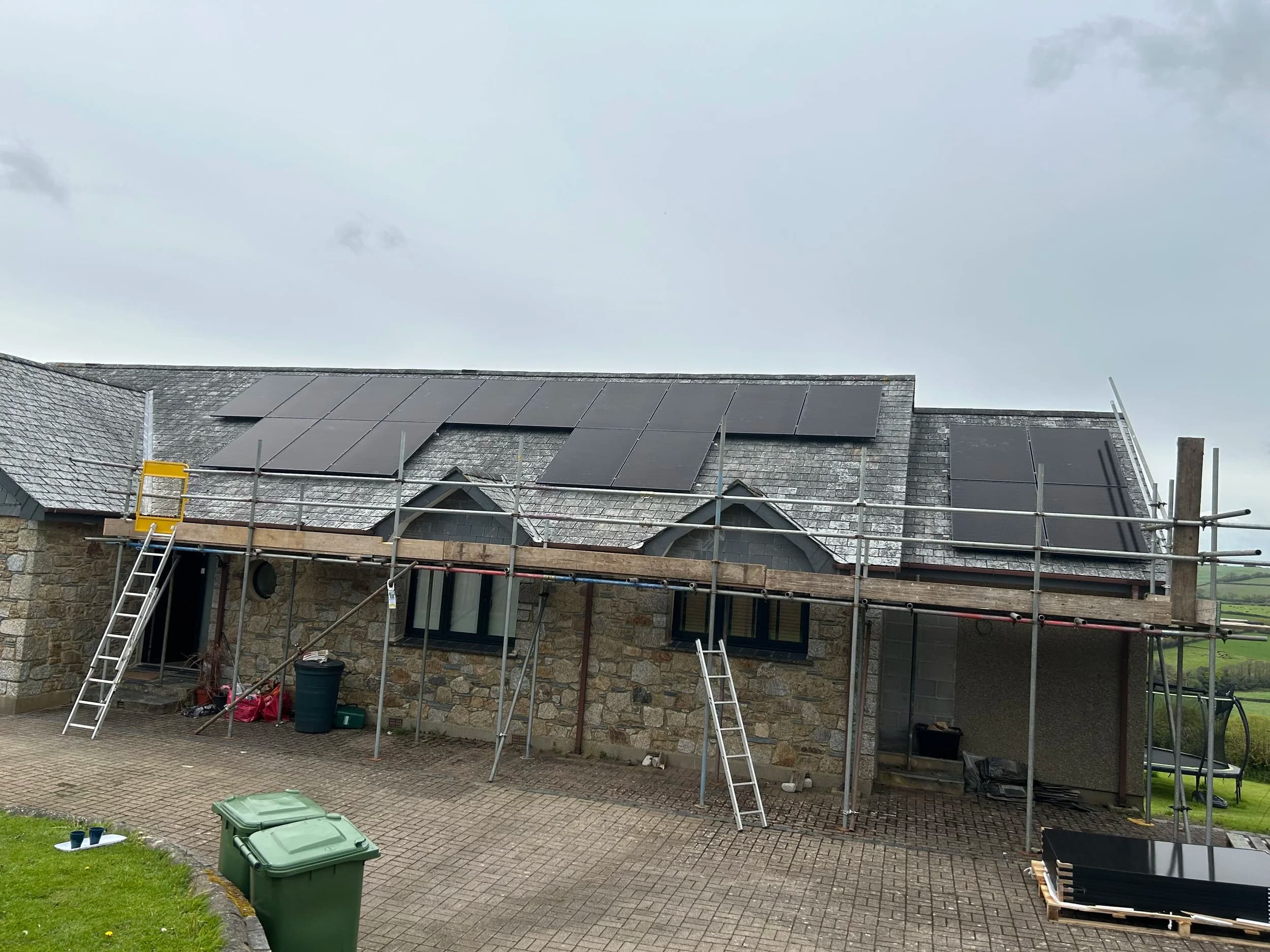 Scaffolding up for a solar installation on a stone-built home.