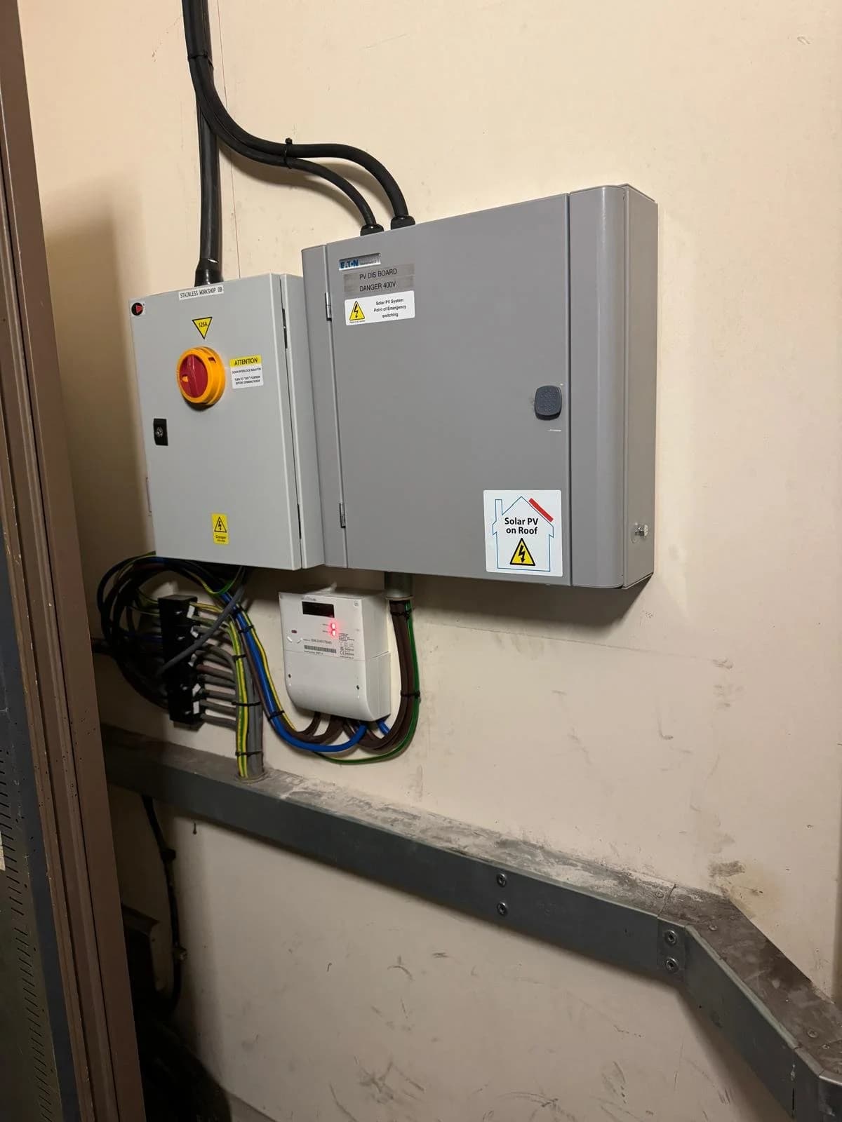Solar isolator switches and a distribution box mounted on a workshop wall