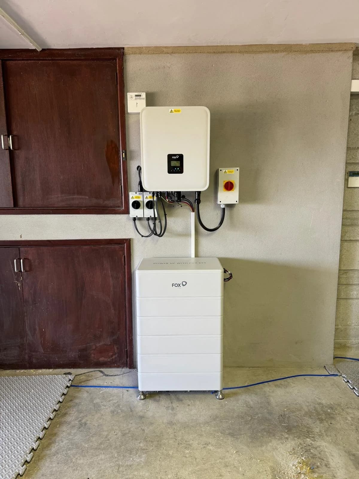 A FoxESS inverter and battery installed in the garage at Dolcoath