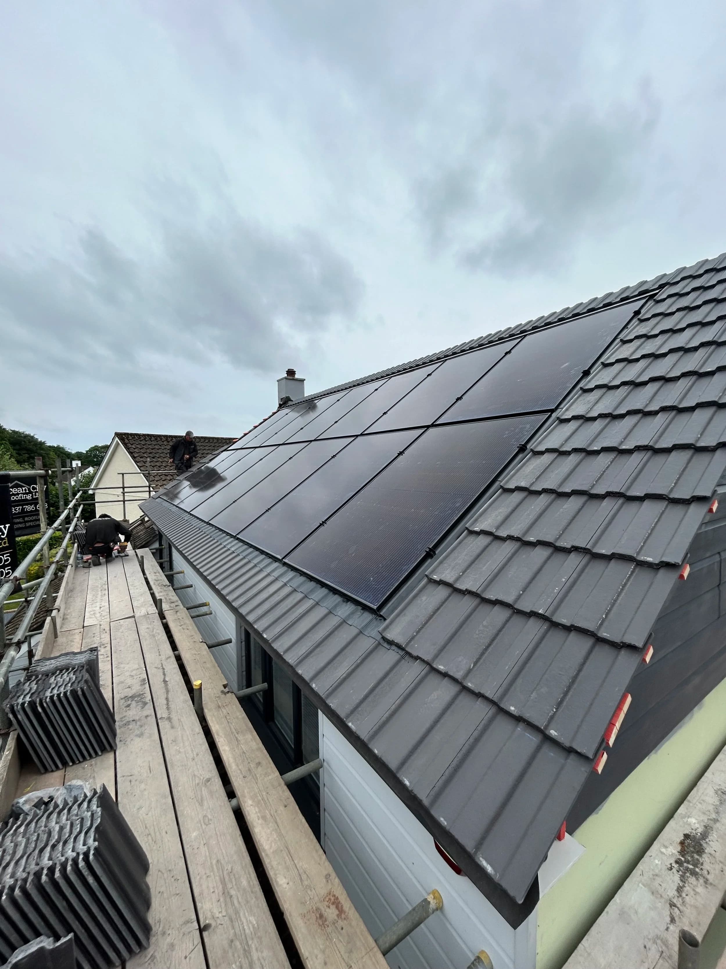 The black solar panels on the roof at Little Fancy Close, seen from the scaffolding