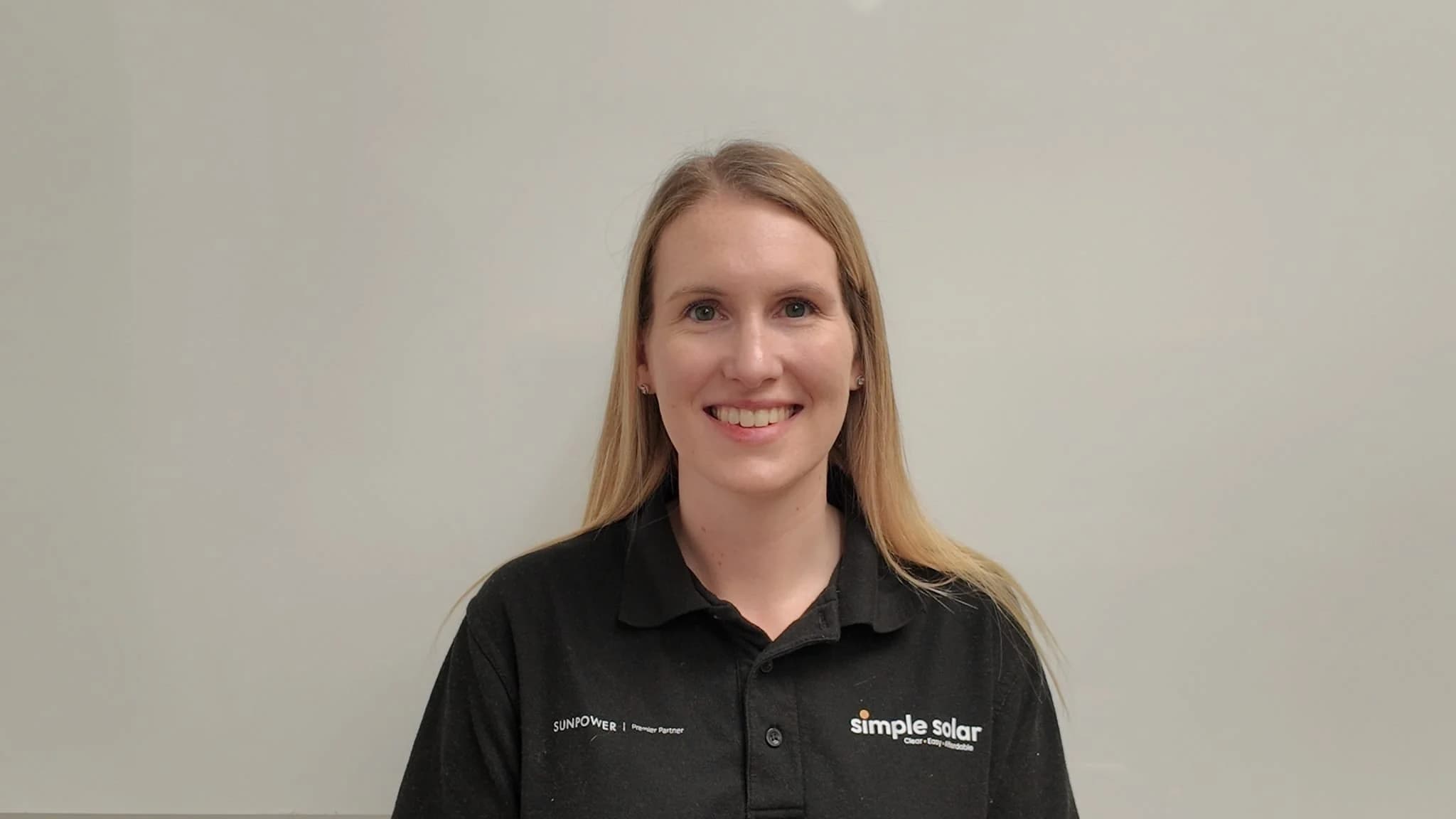 Headshot of Hannah Harvey wearing a Simple Solar black polo shirt.