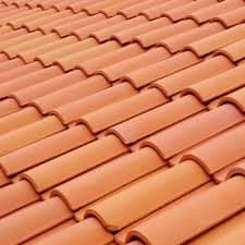 Close-up of terracotta roof tiles in overlapping rows.