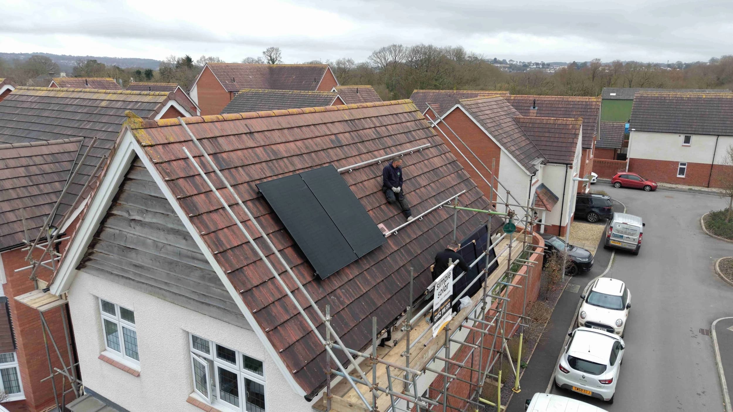 Solar installers fitting panels on a South West UK home