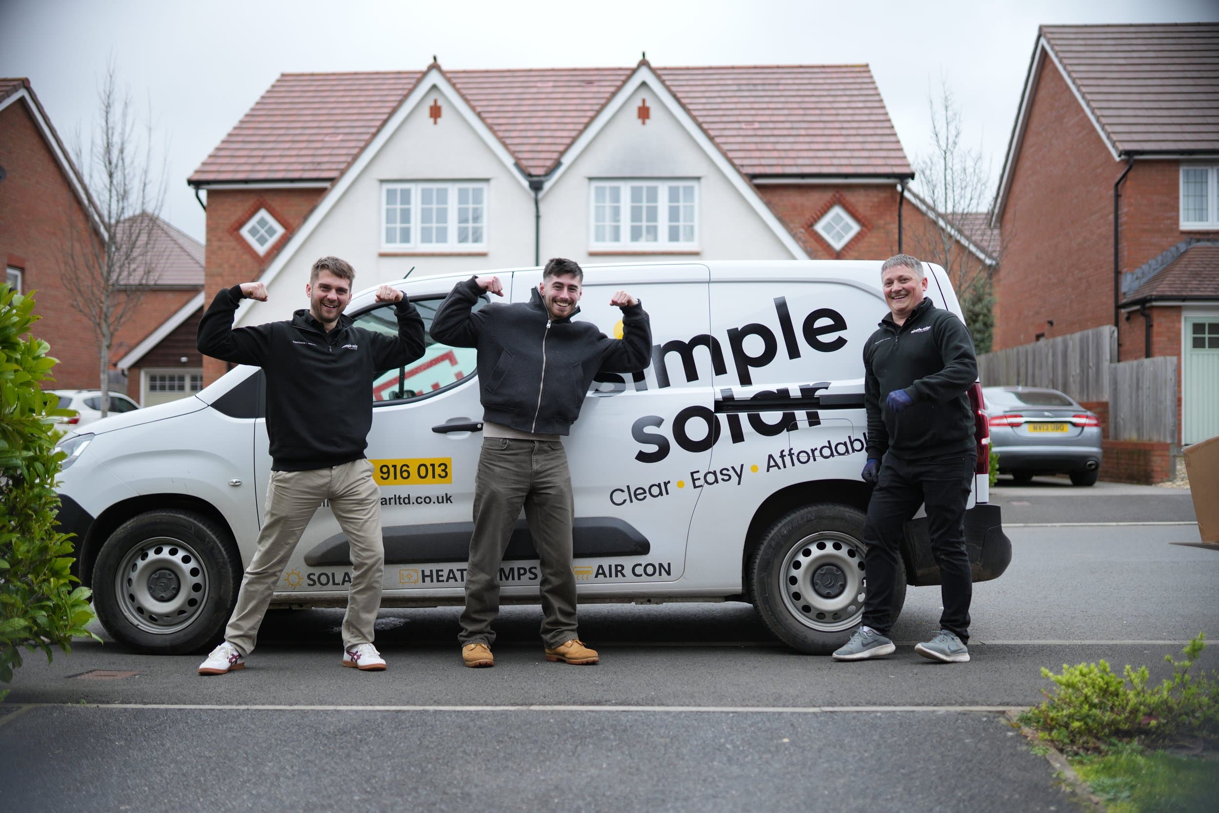 Three of the Simple Solar team standing in front of their branded van.