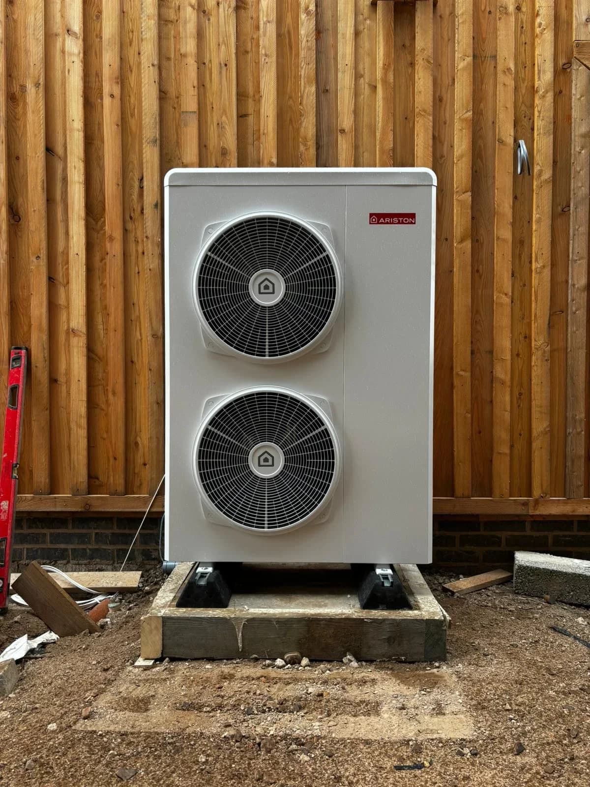Outdoor heat pump unit installed on a base.