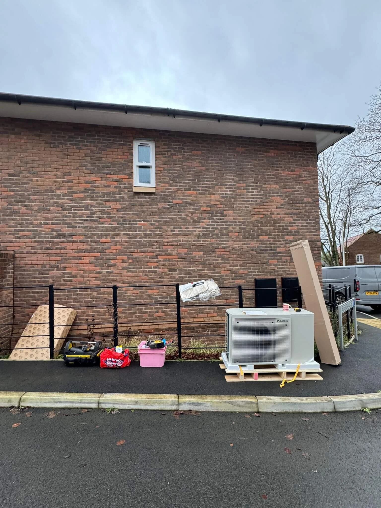 Image showing an air source heat pump outdoor unit installed with tools ready to be installed.