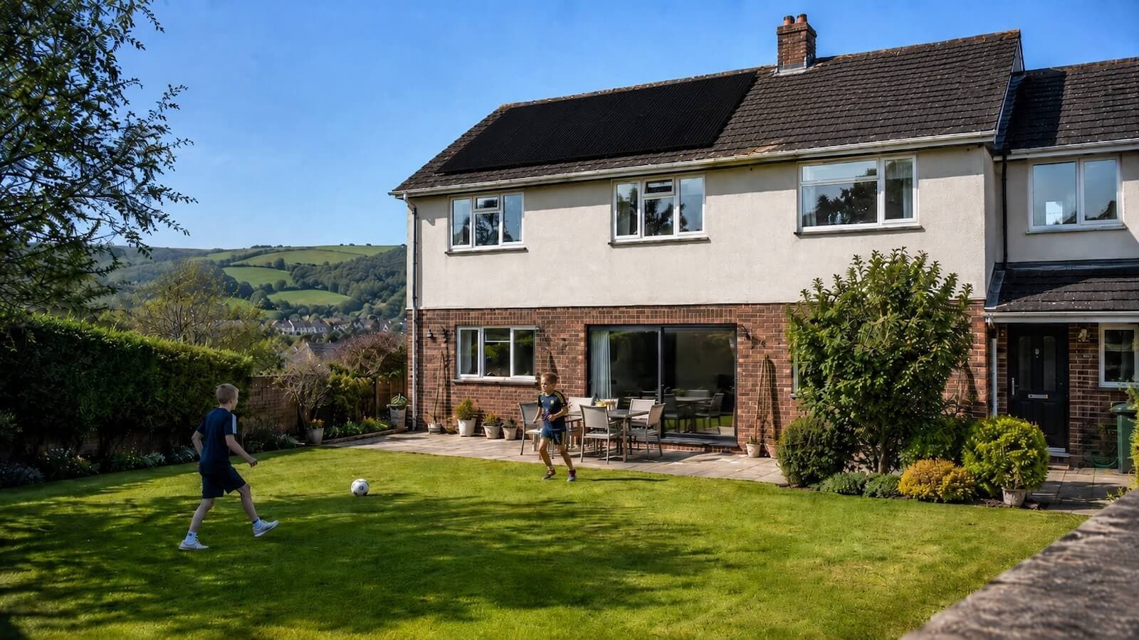 Residential solar panel installation on a family home in Newton Abbot, south Devon, with rolling countryside in the background.